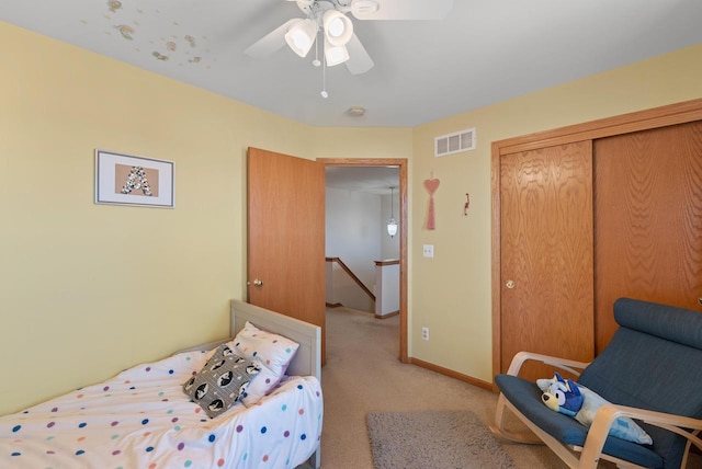 bedroom with visible vents, a ceiling fan, a closet, carpet, and baseboards