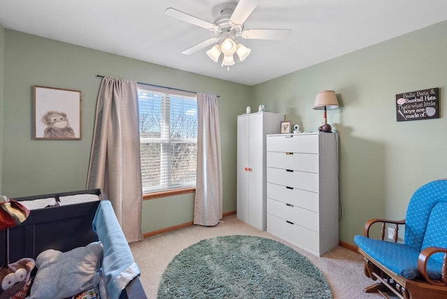 bedroom featuring light carpet, baseboards, and ceiling fan