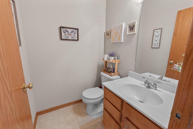 half bathroom with tile patterned floors, baseboards, toilet, and vanity