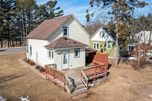 back of property featuring a wooden deck and a shingled roof