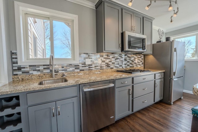 kitchen with a sink, appliances with stainless steel finishes, gray cabinetry, and crown molding