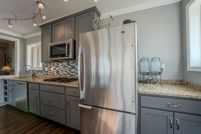 kitchen featuring a sink, ornamental molding, gray cabinets, and stainless steel appliances