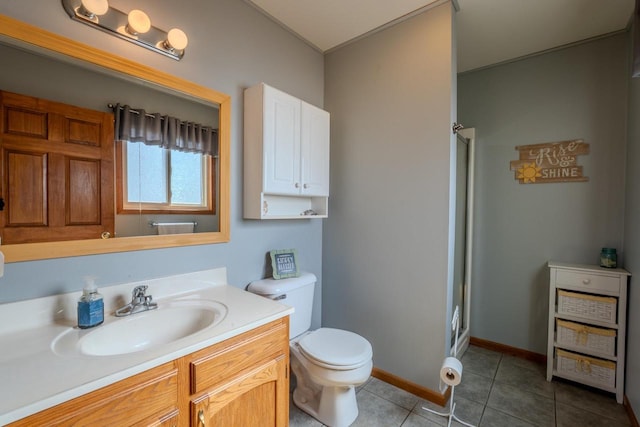 bathroom featuring baseboards, toilet, a stall shower, tile patterned floors, and vanity