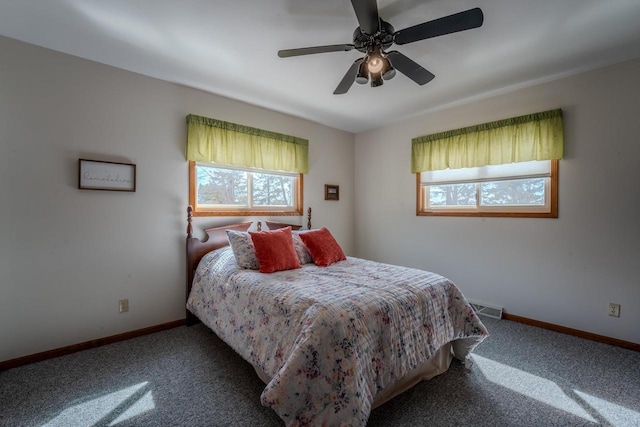 carpeted bedroom featuring visible vents, baseboards, and ceiling fan