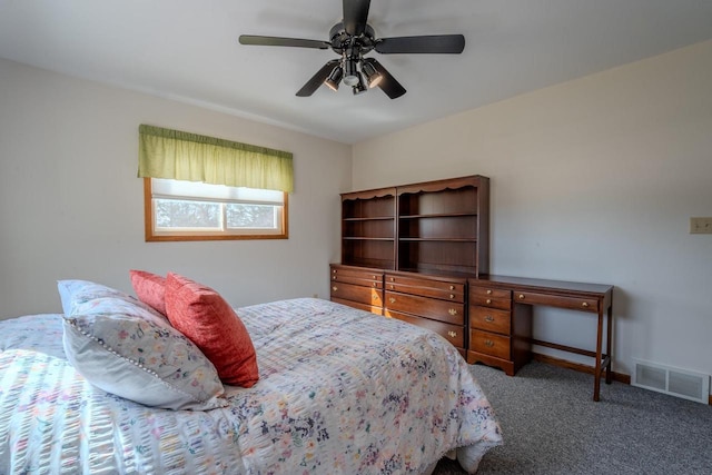 carpeted bedroom with visible vents, baseboards, and a ceiling fan