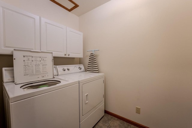 laundry room featuring light tile patterned floors, cabinet space, baseboards, and separate washer and dryer