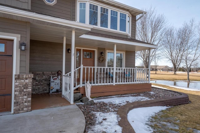 view of exterior entry with covered porch