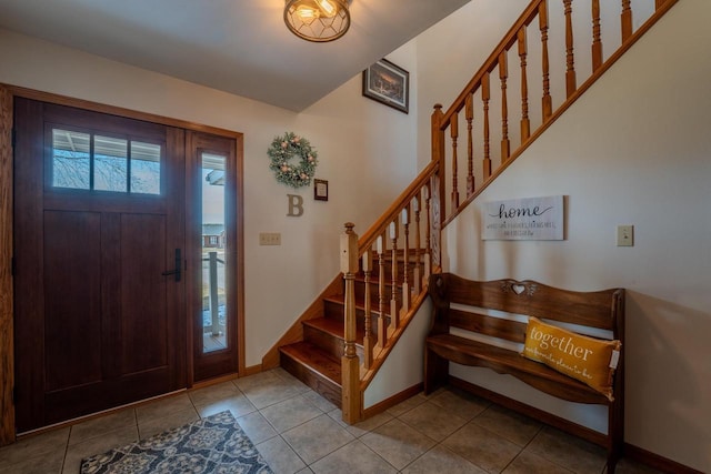 entryway featuring tile patterned flooring, stairs, and baseboards