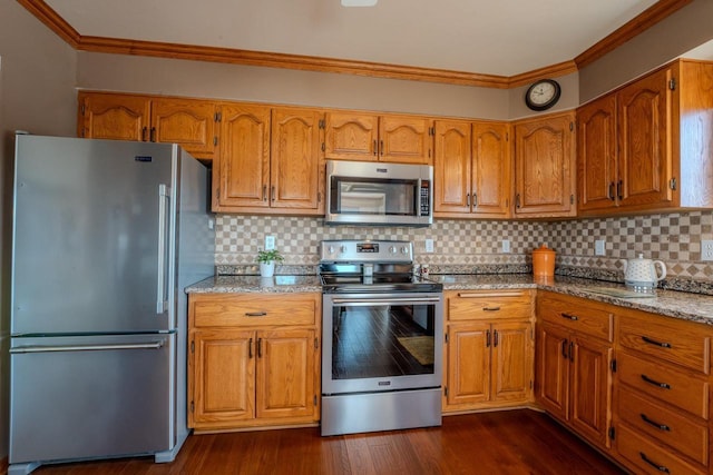 kitchen with crown molding, dark wood-style floors, brown cabinets, and stainless steel appliances