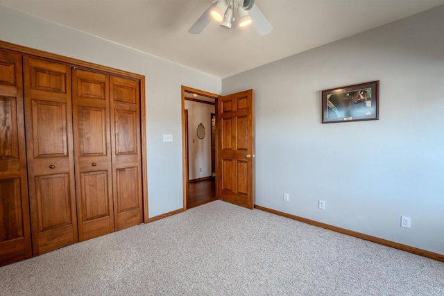 unfurnished bedroom featuring a closet, ceiling fan, baseboards, and carpet floors