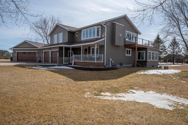 view of front of home with a porch, an attached garage, and driveway