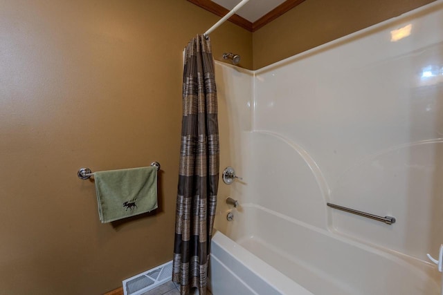 bathroom featuring visible vents, shower / bath combination with curtain, and crown molding