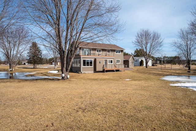 back of house featuring crawl space, a yard, and a balcony