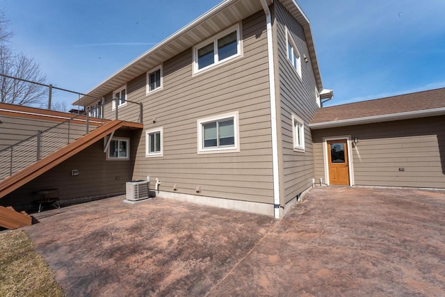 rear view of house with stairway, a patio, a wooden deck, and central AC