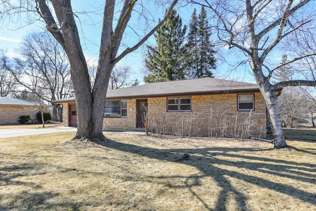 single story home featuring a front lawn, a garage, stone siding, and roof with shingles