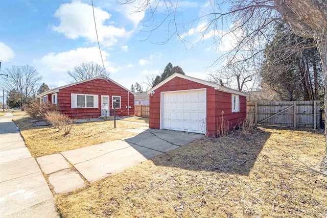 detached garage with driveway and fence