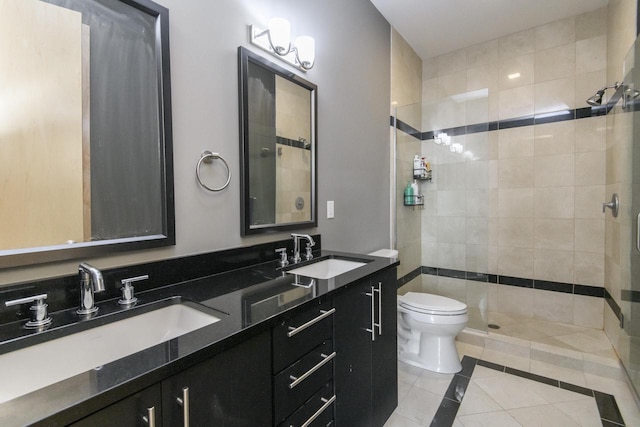 full bath with tile patterned floors, a tile shower, and a sink