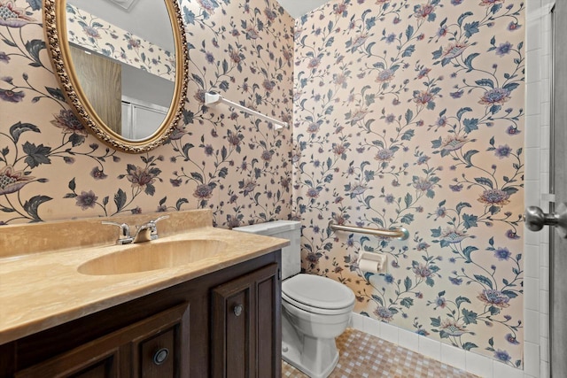 bathroom featuring wallpapered walls, toilet, vanity, and tile patterned flooring