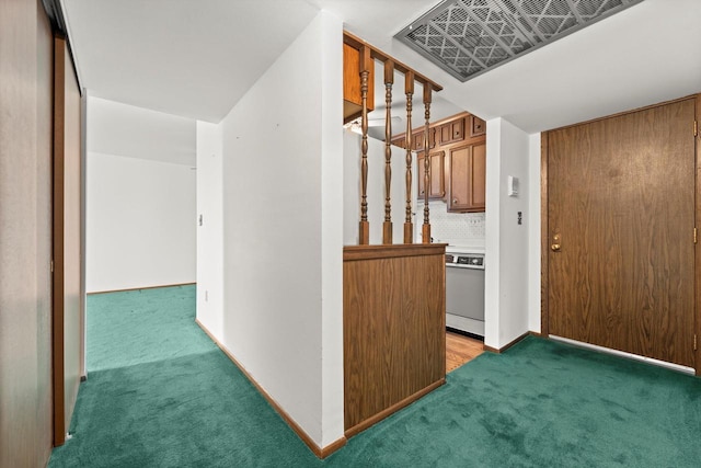 interior space with carpet flooring, baseboards, and visible vents