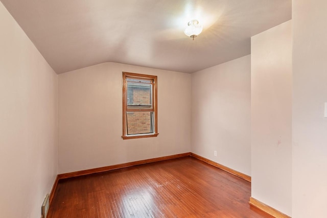 bonus room featuring vaulted ceiling, baseboards, and wood-type flooring