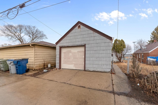 detached garage featuring concrete driveway