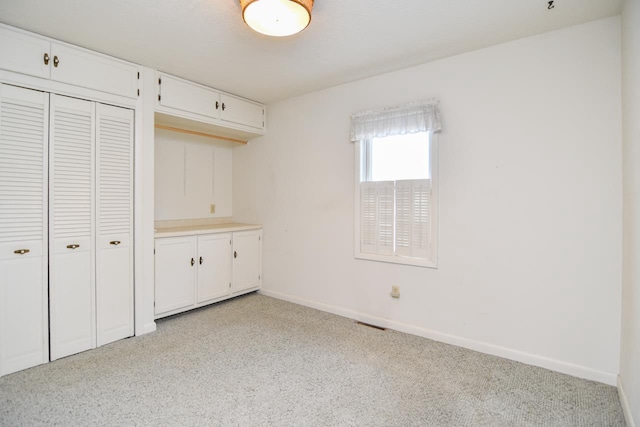 unfurnished bedroom with a closet and baseboards