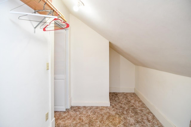 additional living space featuring baseboards, carpet, and vaulted ceiling