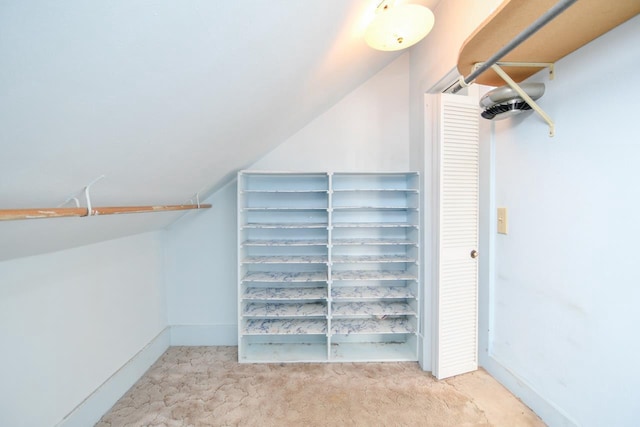 spacious closet with carpet and vaulted ceiling