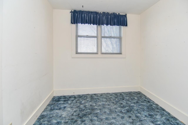 spare room featuring baseboards and carpet floors