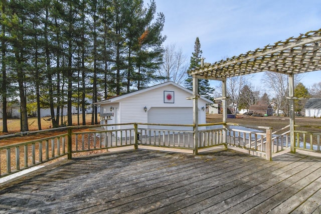 deck with an outbuilding, a pergola, and a detached garage