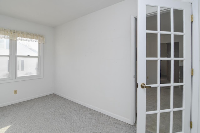 unfurnished room featuring baseboards and carpet