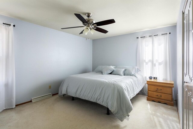 bedroom with light carpet, visible vents, baseboards, and ceiling fan