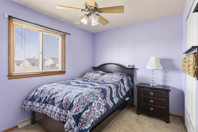 carpeted bedroom featuring a baseboard radiator, baseboards, and ceiling fan