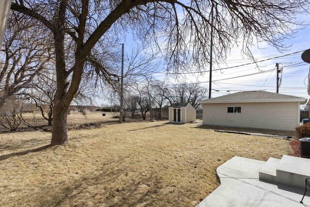 view of yard featuring an outbuilding and a storage unit