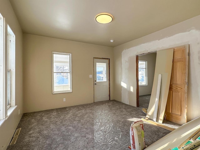 entrance foyer with visible vents and carpet