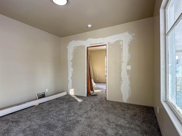 empty room featuring a healthy amount of sunlight and carpet