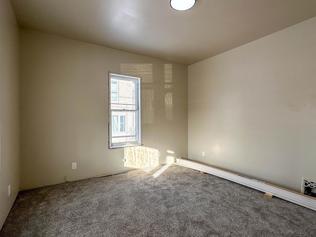 carpeted spare room with vaulted ceiling