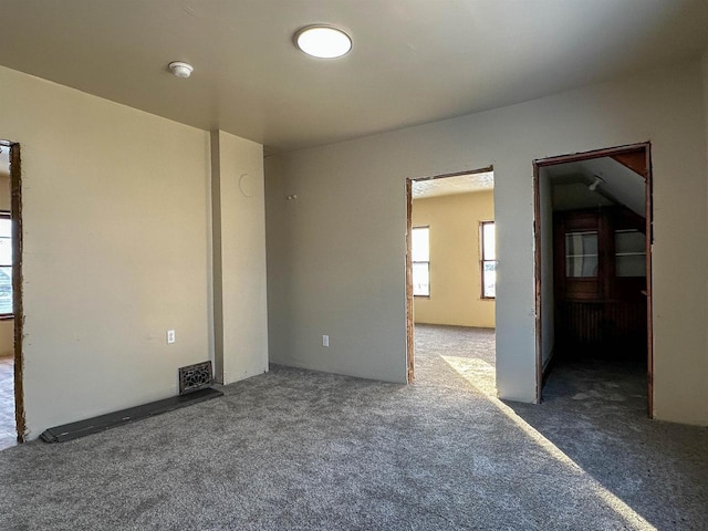 unfurnished room with visible vents and carpet floors