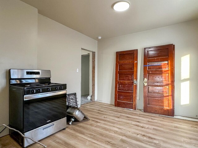 kitchen with stainless steel range with gas stovetop and light wood-type flooring