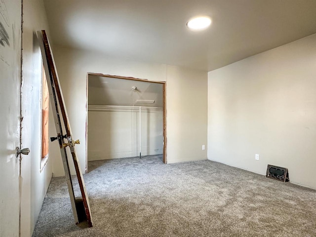 unfurnished bedroom featuring a closet and carpet flooring