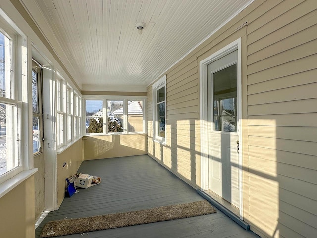 unfurnished sunroom featuring wood ceiling