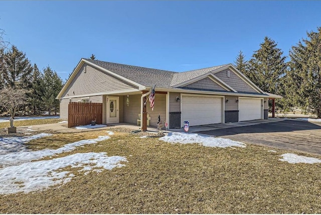 view of front facade featuring aphalt driveway and an attached garage