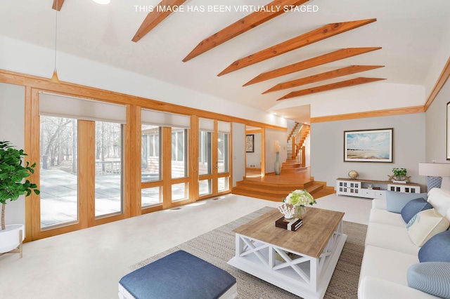 carpeted living room featuring lofted ceiling with beams and stairs