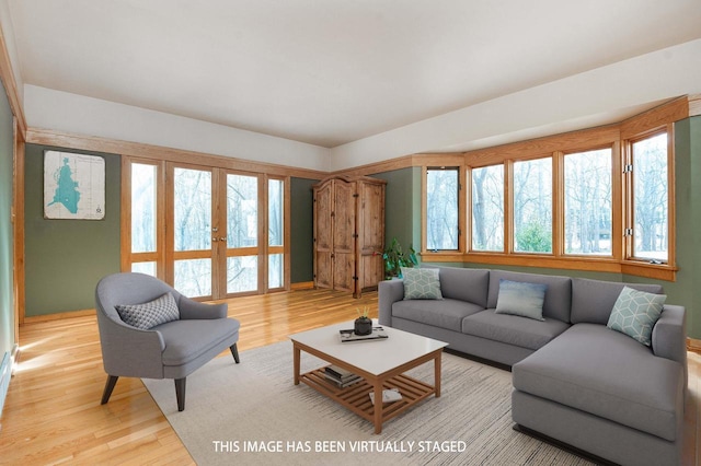 living area featuring wood finished floors and french doors