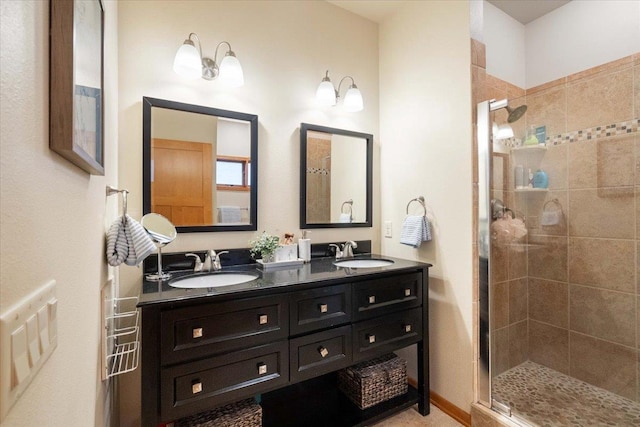 full bathroom featuring a shower stall, double vanity, and a sink