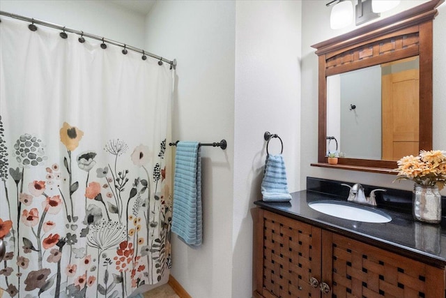 full bathroom with curtained shower and vanity