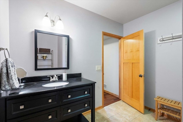 bathroom featuring baseboards and vanity