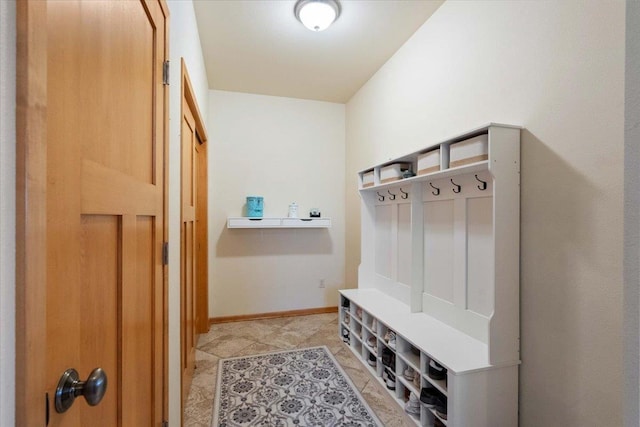 mudroom with light tile patterned floors and baseboards