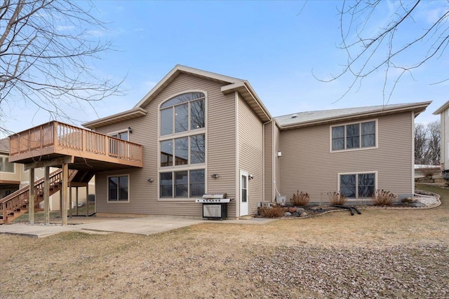 back of house featuring a patio area, a wooden deck, and stairs