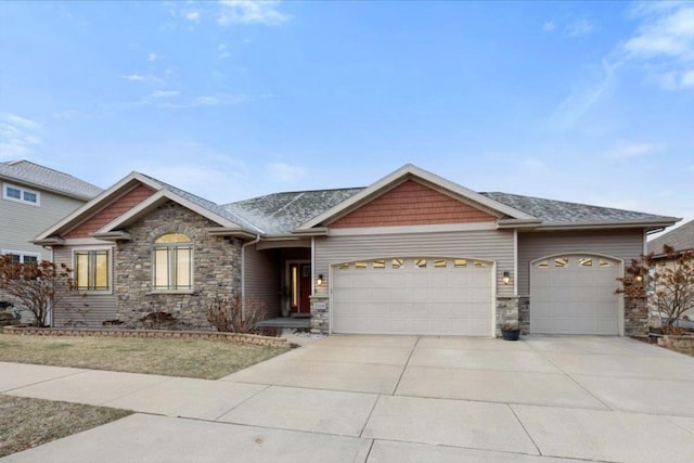 view of front of house with stone siding, concrete driveway, and a garage